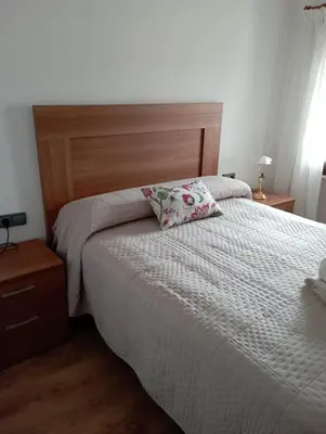 a bedroom with a bed with a pillow on it at Casa rural La Barriada de Lago de Carucedo in Lago de Carucedo
