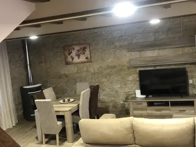 a living room with a couch and a television at A Casa de Abaixo in Cuntis