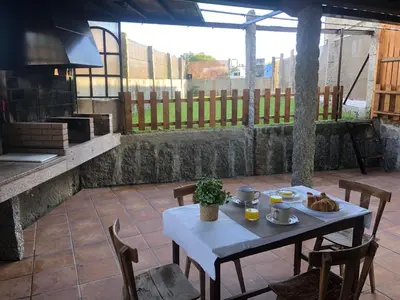 a white table and chairs on a patio at A Casa de Abaixo in Cuntis