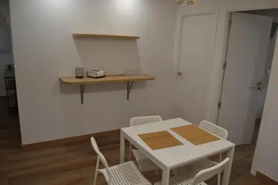 a white table and chairs in a room at Greco 8 in Sarria