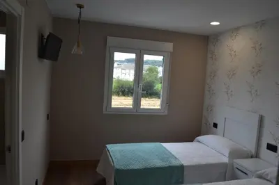 a bedroom with a bed and a window at Greco 8 in Sarria
