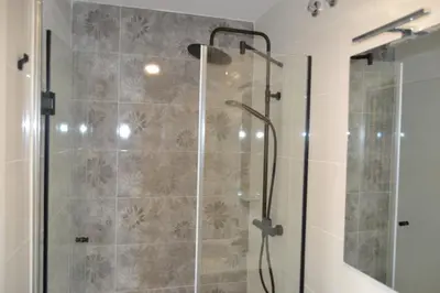 a bathroom with a shower with a glass door at Greco 8 in Sarria