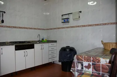a kitchen with a counter and a sink and a table at Albergue los Blasones in Sarria