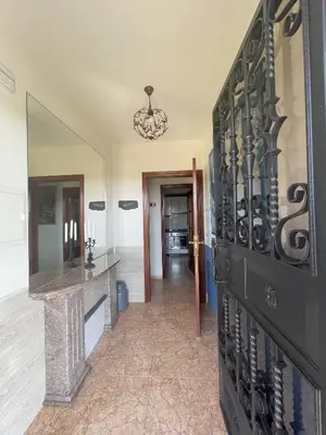 a hallway with a large black door in a house at Toxiños Lavacolla in A Coruña