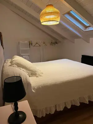 a bedroom with a bed and a lamp on a table at Casa El Santanderino in El Espino