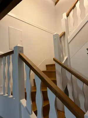 a staircase in a home with white walls and wood floors at Casa El Santanderino in El Espino