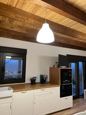 a kitchen with white cabinets and a light fixture at Casa El Santanderino in El Espino