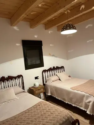 a bedroom with two beds and a flat screen tv at Casa El Santanderino in El Espino