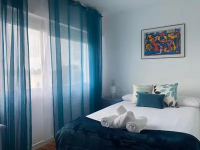 a bedroom with a bed with towels on it at Magnífica casa independiente by beBalmy in Santiago de Compostela