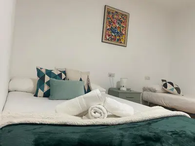 a bedroom with a bed with a towel on it at Magnífica casa independiente by beBalmy in Santiago de Compostela