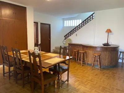 a dining room with a table and a piano at Magnífica casa independiente by beBalmy in Santiago de Compostela