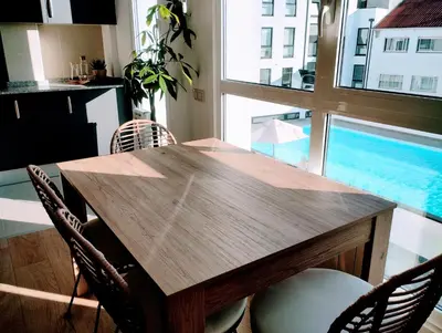 a dining room table with chairs and a large window at Apartamento en Sada con Piscina in Sada
