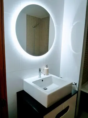 a bathroom with a white sink and a mirror at Apartamento en Sada con Piscina in Sada