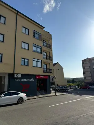 a white car parked in front of a building at Apartamento moderno en Valga ideal para peregrinos y familias, junto al Camino de Santiago in Pontevedra
