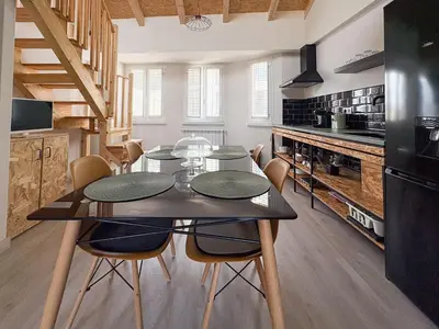 a dining room with a table and chairs in a kitchen at Apartamentos Ribadeo in Ribadeo