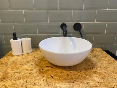 a white bowl sitting on top of a counter at Apartamentos Ribadeo in Ribadeo