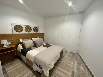 a bedroom with a large bed and white cabinets at Casa Bela I Apart Lux Santiago in Santiago de Compostela