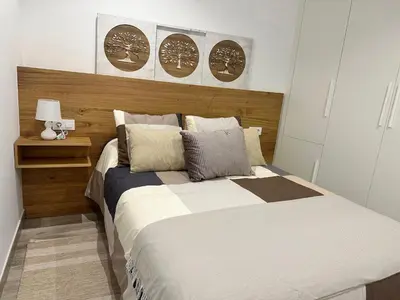 a bedroom with a bed and two plates on the wall at Casa Bela I Apart Lux Santiago in Santiago de Compostela