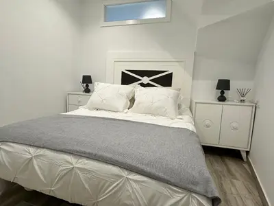 a white bedroom with a large bed with white furniture at Casa Bela I Apart Lux Santiago in Santiago de Compostela
