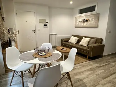 a living room with a table and chairs and a couch at Casa Bela I Apart Lux Santiago in Santiago de Compostela
