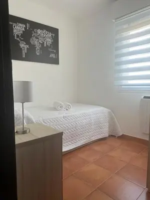 a bedroom with a bed with a table and a window at Ensino 22 in Ourense