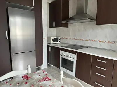 a kitchen with a refrigerator and a stove top oven at Ensino 22 in Ourense