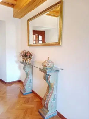 a console table with a mirror on a wall at Casa Lolita 2 in Viveiro