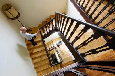 a man standing on the stairs of a house at Santa Emilia in Mondoñedo