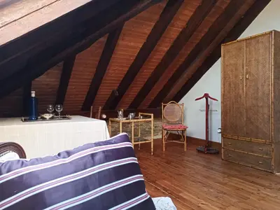 a living room with a bed and a wooden ceiling at Santa Emilia in Mondoñedo
