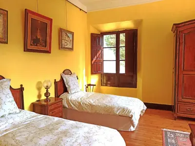 a bedroom with two beds and a window at Santa Emilia in Mondoñedo