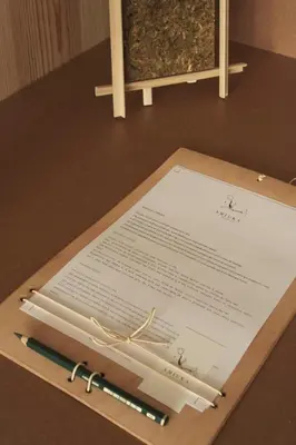 a piece of paper with two pens on a table at Hotel Amiuka in O Pedrouzo