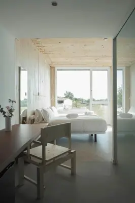 a bedroom with a bed and a table and a bench at Hotel Amiuka in O Pedrouzo