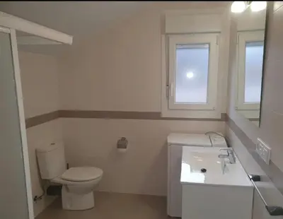 a white bathroom with a toilet and a sink at CANTABRICO in Barreiros