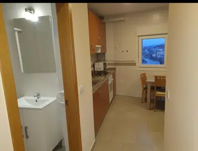a small kitchen with a sink and a table at CANTABRICO in Barreiros