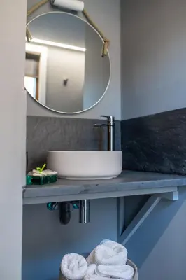 a bathroom with a sink and a mirror at O rincón dos Sentidos in Cenlle