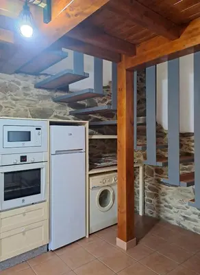 a kitchen with a refrigerator and a dishwasher at CASA ARABIA in Monforte de Lemos