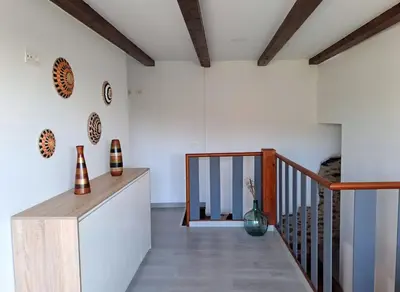 a room with white walls and a staircase with vases on the wall at CASA ARABIA in Monforte de Lemos