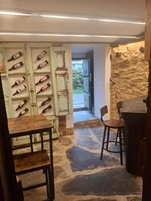 a room with a wall of wine bottles at CASA ARABIA in Monforte de Lemos