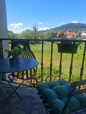 a table and a chair on a balcony with a view at CASA ARABIA in Monforte de Lemos