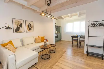 a living room with a white couch and a table at Apartamentos Gurugú in Ribadeo