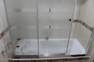 a shower with a glass enclosure in a bathroom at Apartamentos Camino Inglés in Ordes
