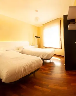 a hallway of a house with a wooden floor at Apartamentos Camino Inglés in Ordes