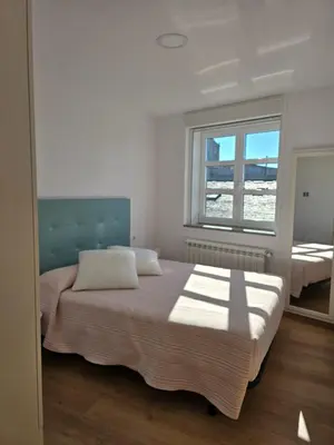 a bedroom with two beds and a window at Pote in Lugo