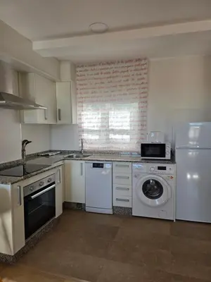 a kitchen with a washing machine and a washer at Pote in Lugo