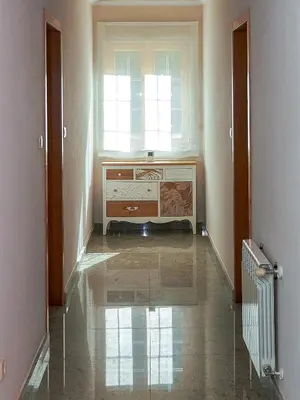 a hallway with a dresser and a window at Casa Río Samo in Garabanja