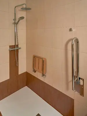 a shower in a bathroom with a tile wall at Casa Río Samo in Garabanja