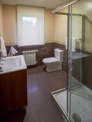 a bathroom with a toilet and a sink and a shower at Casa Río Samo in Garabanja