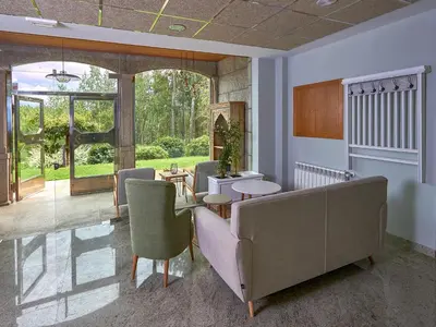 a living room with a couch and a table and chairs at Casa Río Samo in Garabanja