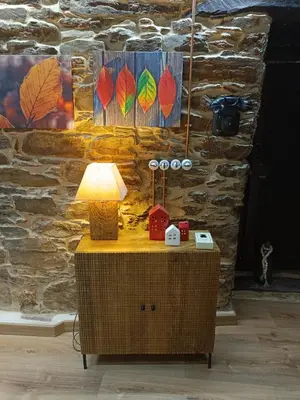 a table with a lamp on top of it at El Rincón del Val in Priaranza del Bierzo