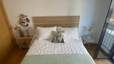 a bed with white sheets and pillows in a bedroom at Casa Sanjurjo in Monforte de Lemos